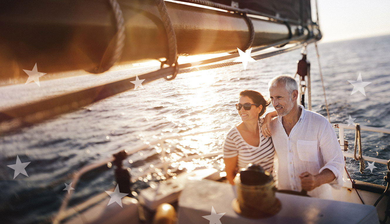 Retired couple on sailboat enjoying the sunset.